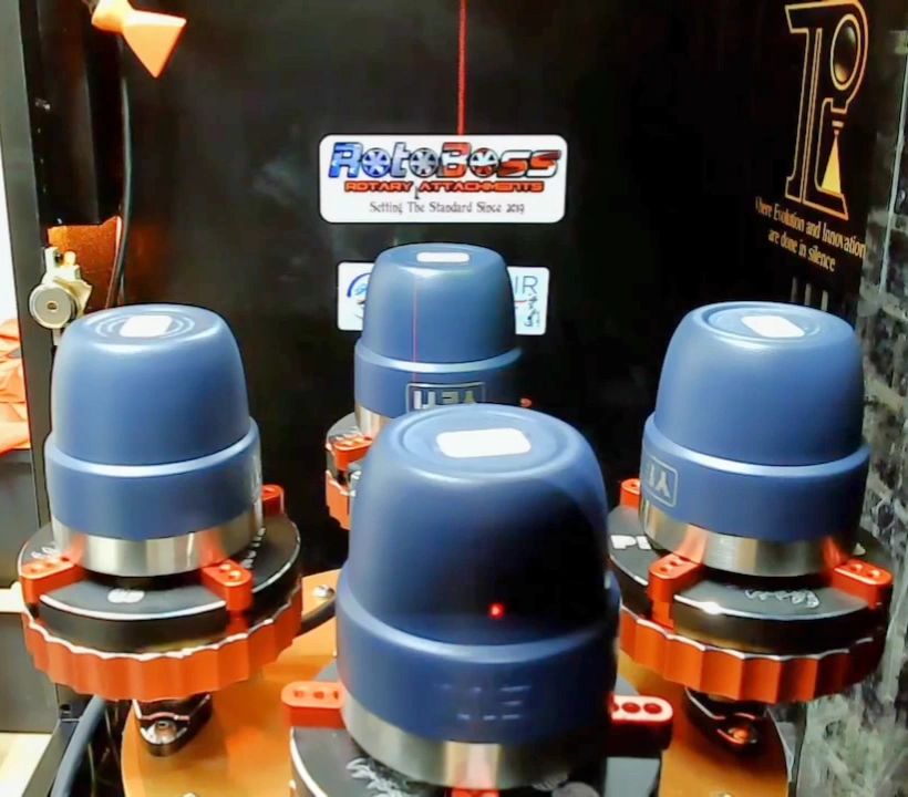 Four tumblers mounted in a Total Performance Lasers and RotoBoss production setup